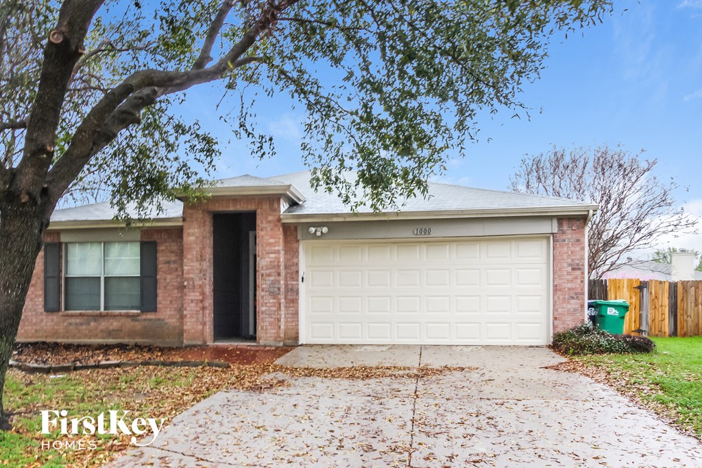 A house with a garage door is for sale.