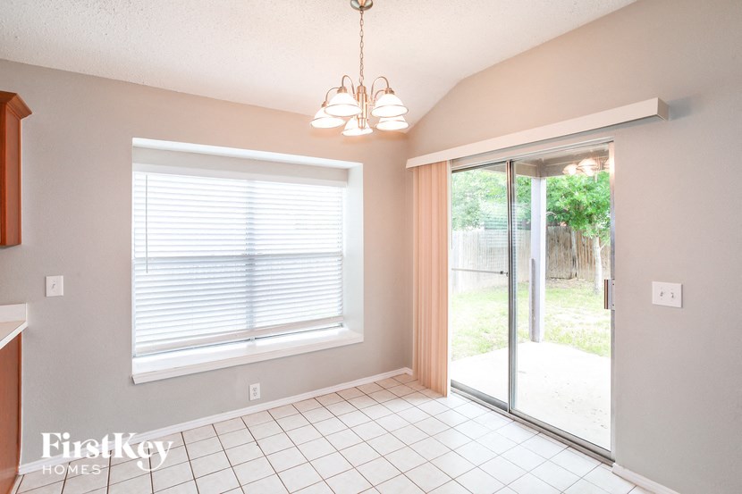A room with a sliding glass door leading to a backyard.