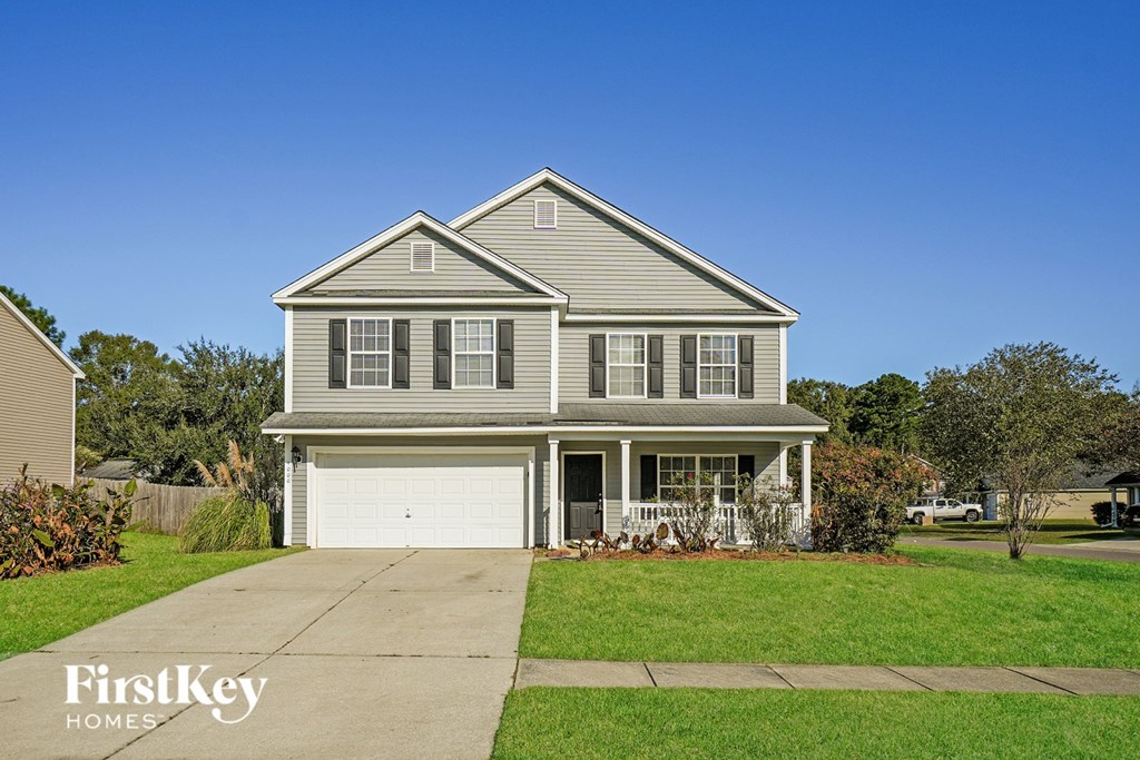 A two-story house with a garage is for sale.