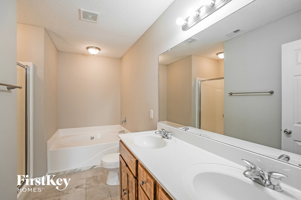 A bathroom with a white sink, toilet, and bathtub.