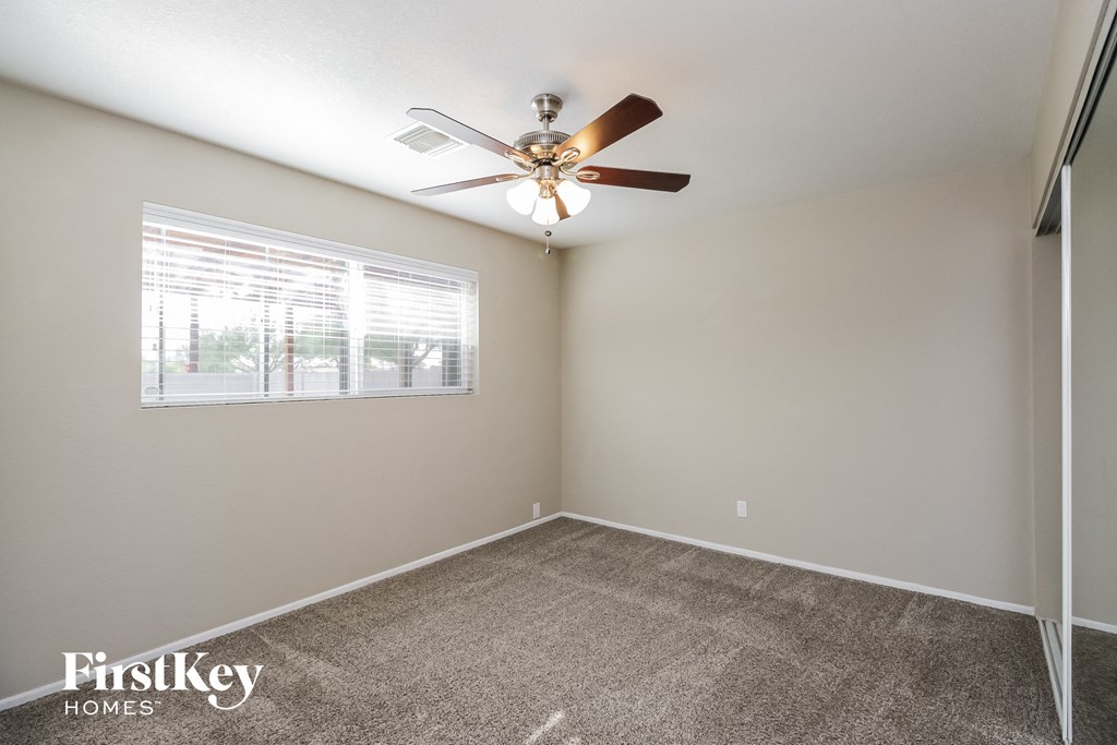 the living room has a ceiling fan and a window