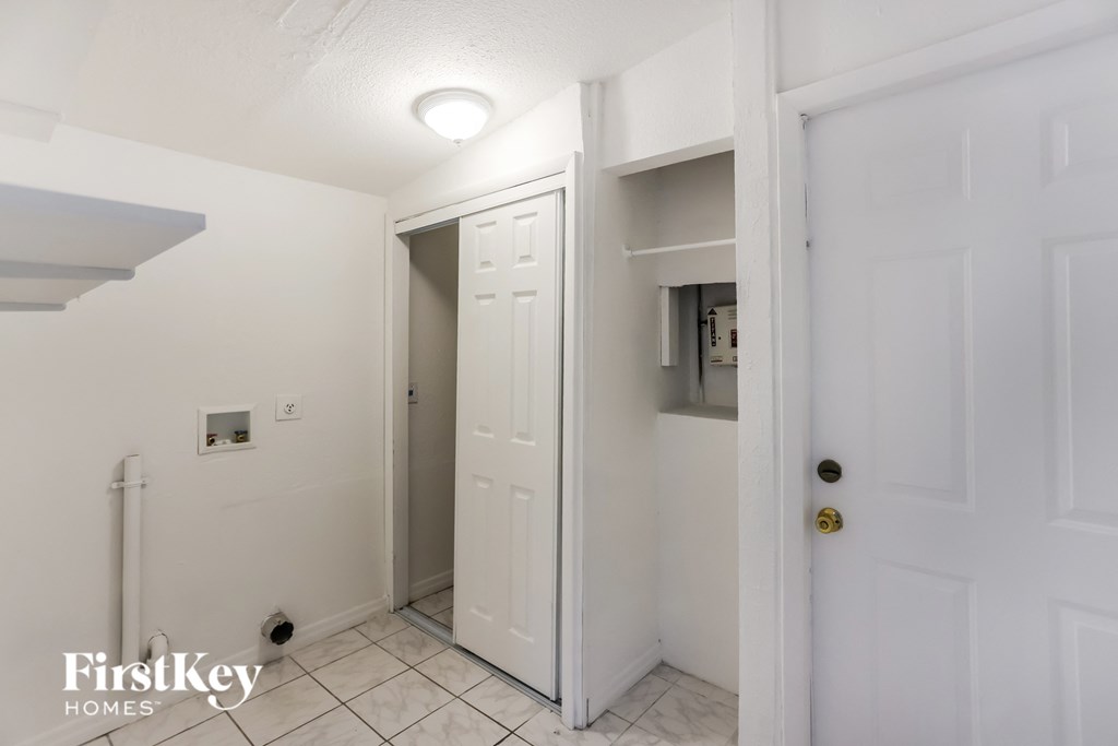 a bathroom with a closet and a door to a hallway