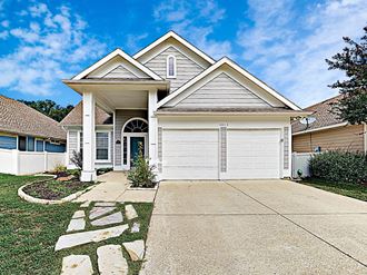 a white house with a driveway and a garage door