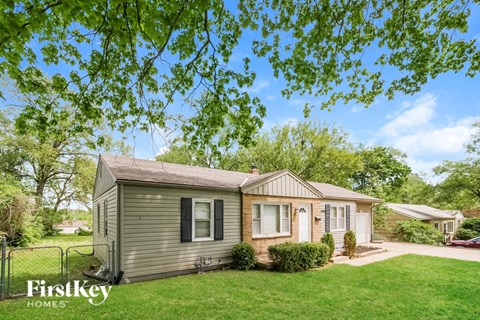 A house with a lawn in front of it.