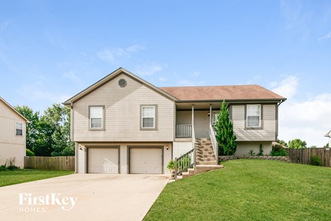 A two-story house with a garage is for sale.