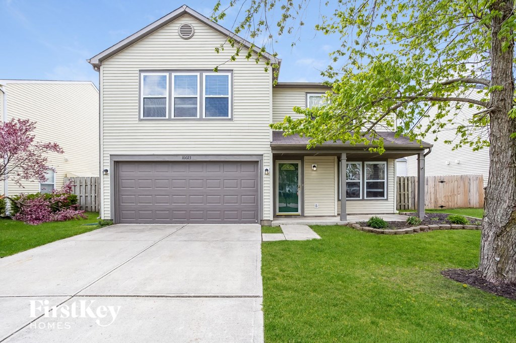a white house with a gray garage door