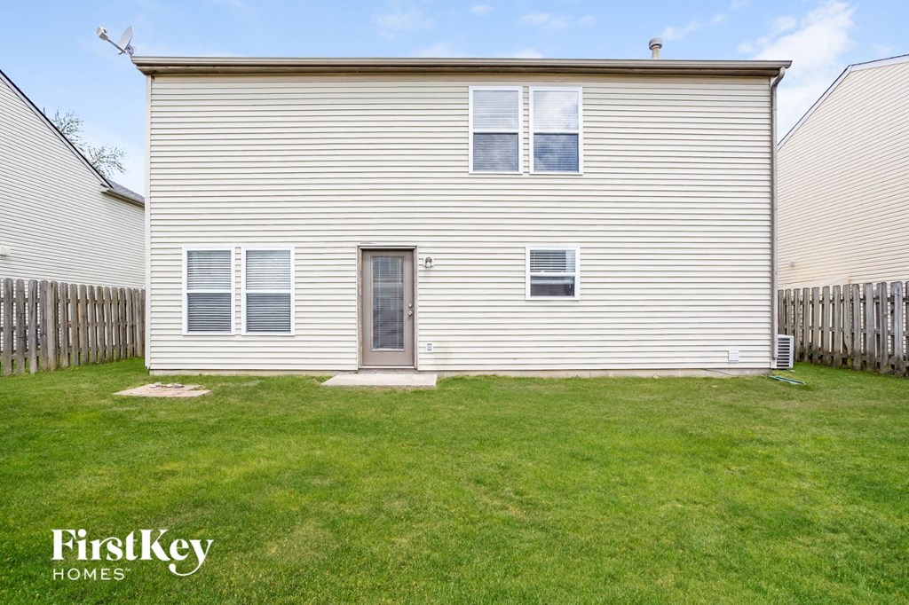 a small white house with a yard in front of it