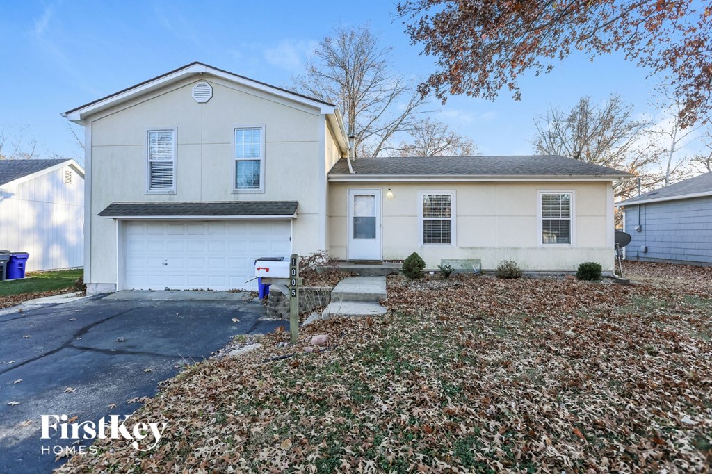 a white house with a driveway in front of it