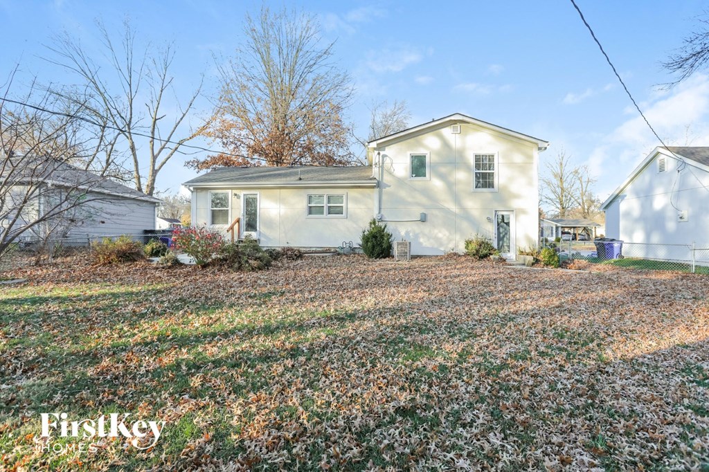 a white house with a yard in front of it