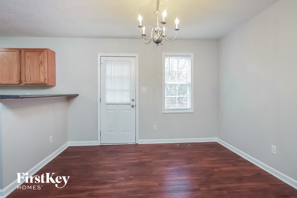 a living room with a wooden floor and a white door