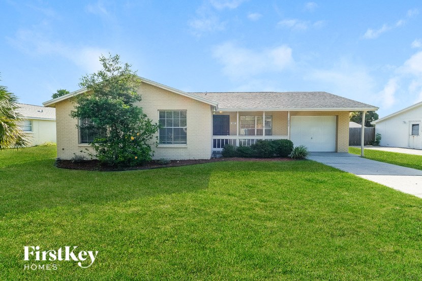 A house with a lawn in front of it.
