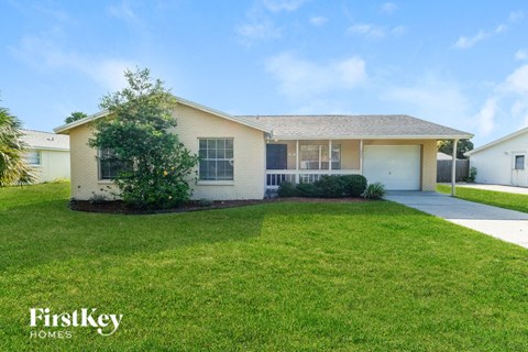 A house with a lawn in front of it.