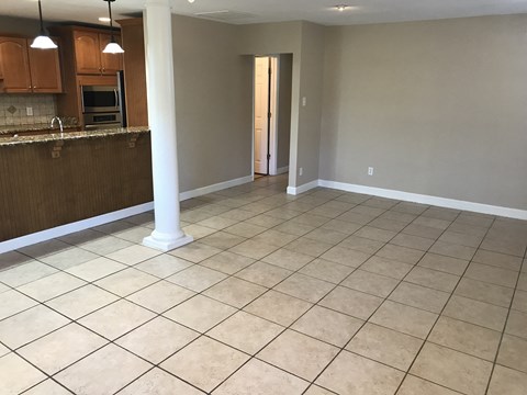A kitchen with brown cabinets and a tiled floor.