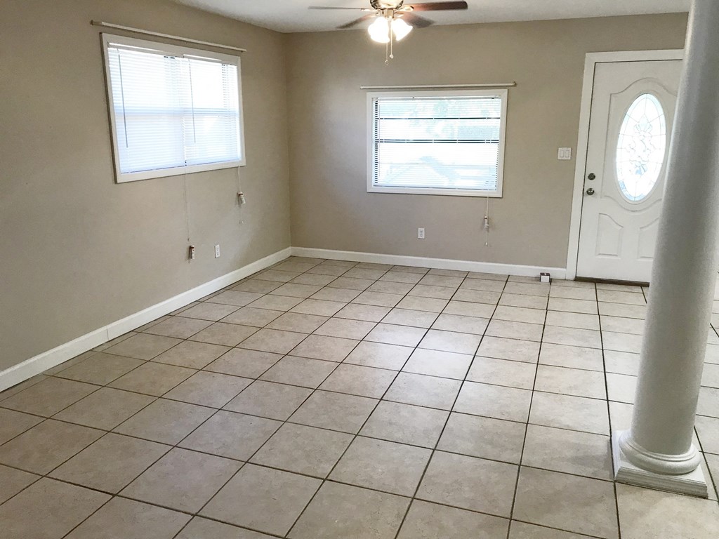 A room with a tiled floor and a ceiling fan.