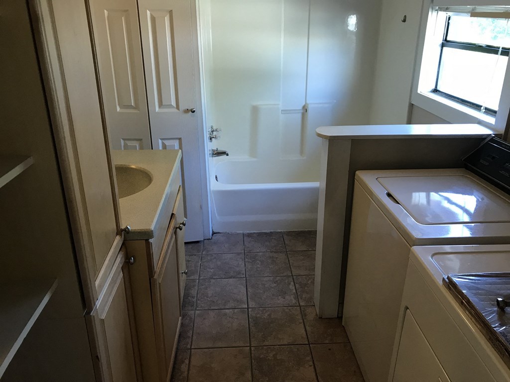 A bathroom with a sink, toilet, and bathtub.
