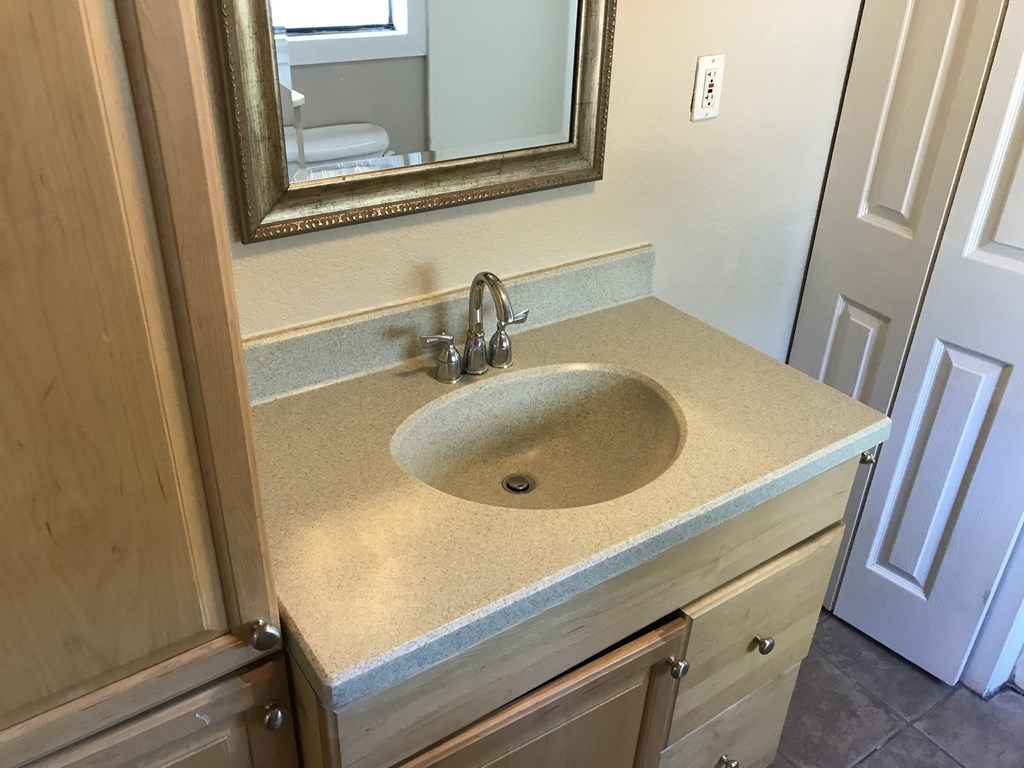 A bathroom sink with a mirror above it.