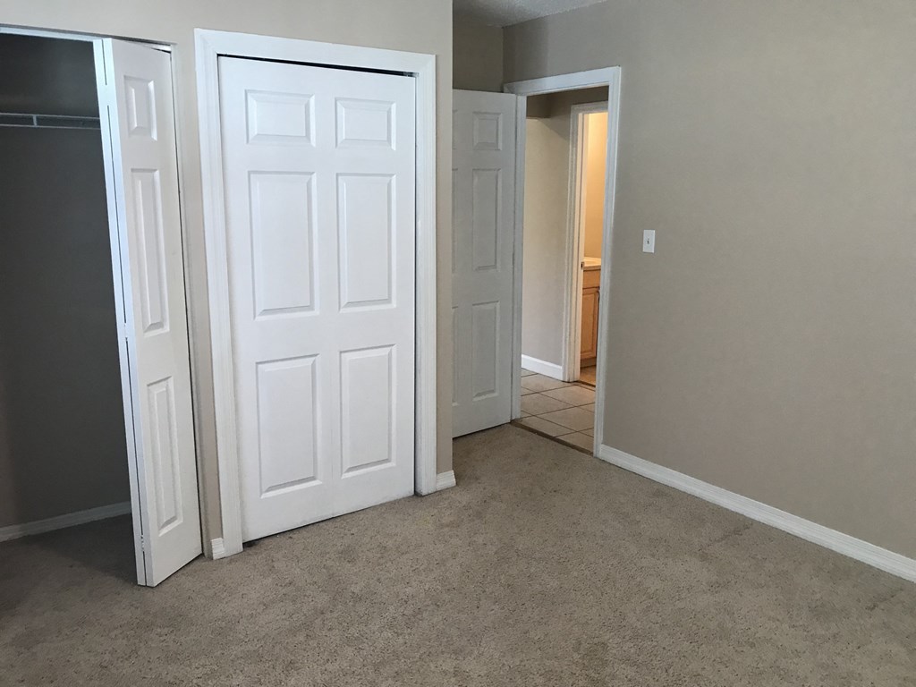 A white door is open to a hallway.