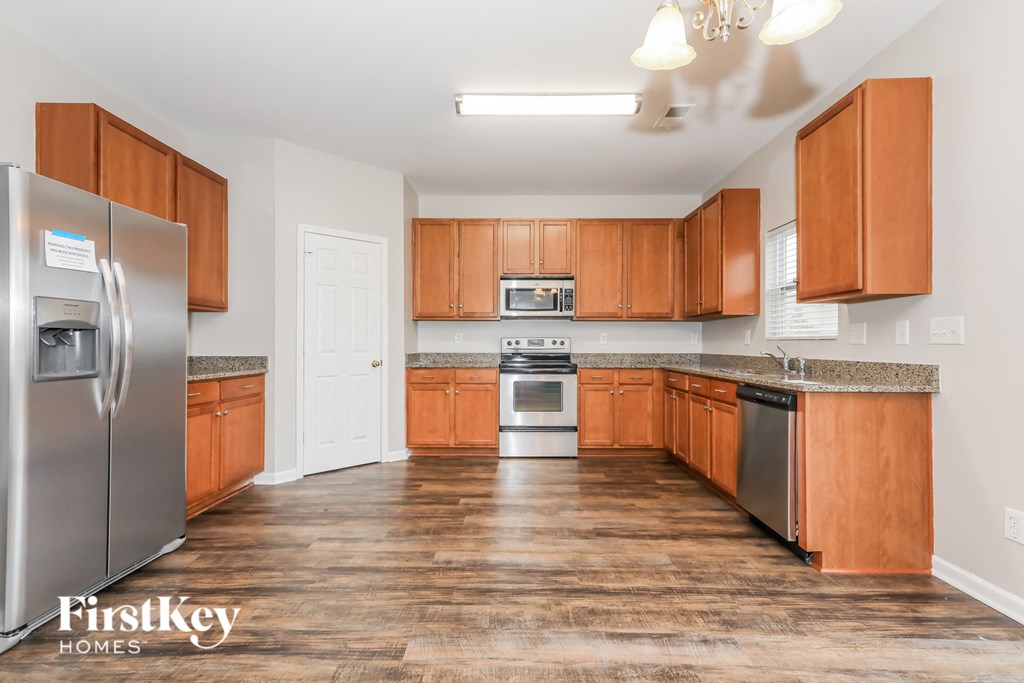 a kitchen with wooden cabinets and stainless steel appliances