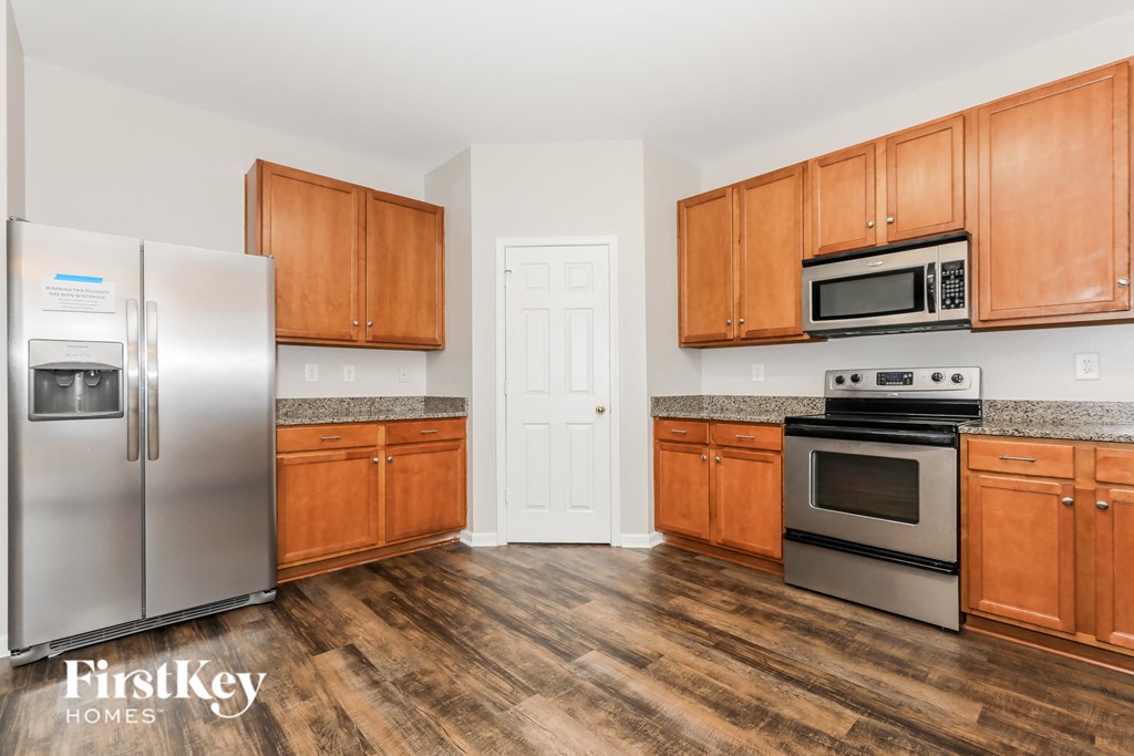a kitchen with wooden cabinets and stainless steel appliances