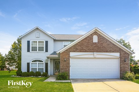 a white house with a white garage door