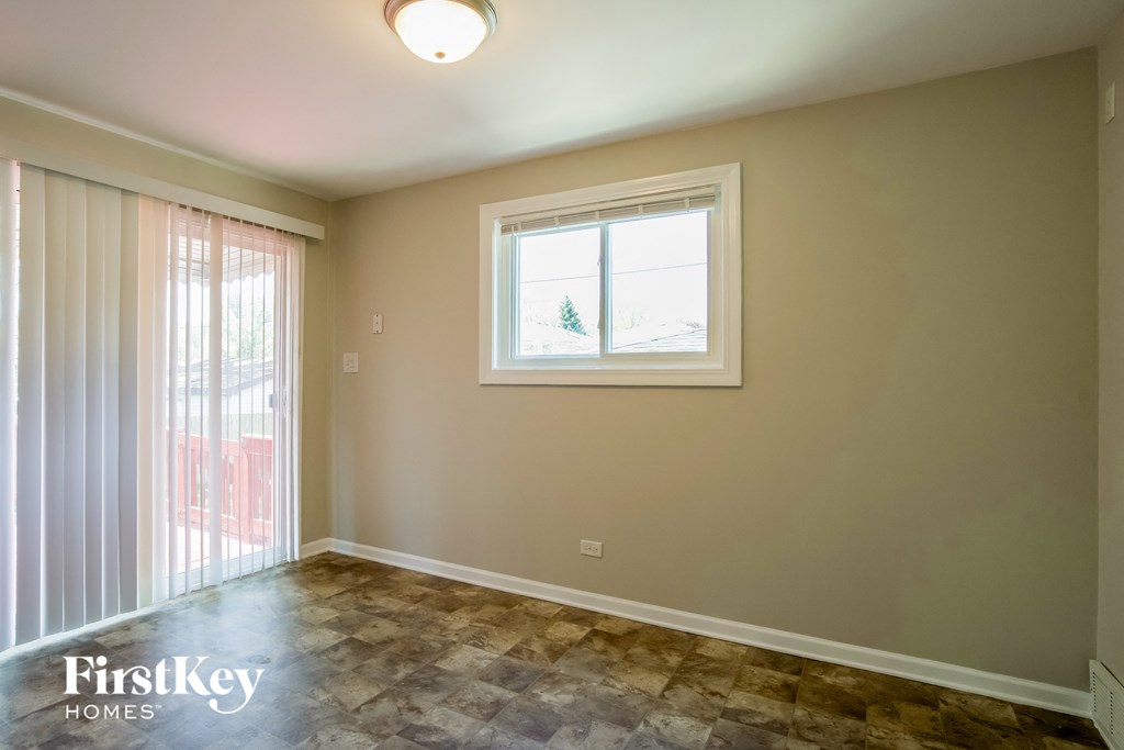 A room with a window and a tiled floor.
