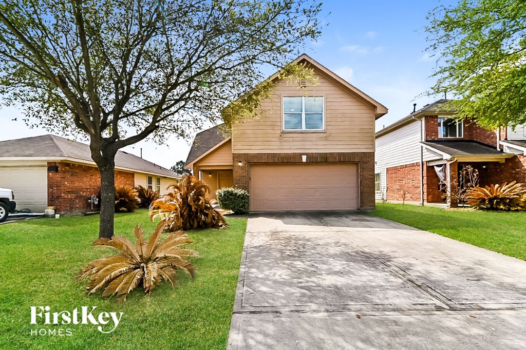 a house with a driveway and a garage door