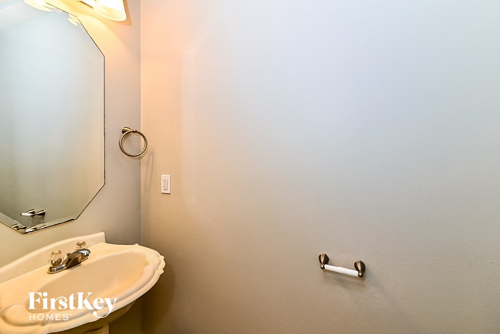 a bathroom with a white sink and a mirror