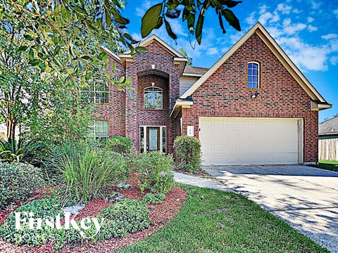 a home with a white garage door in front of it