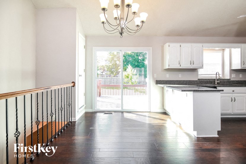an empty kitchen with a door to a balcony