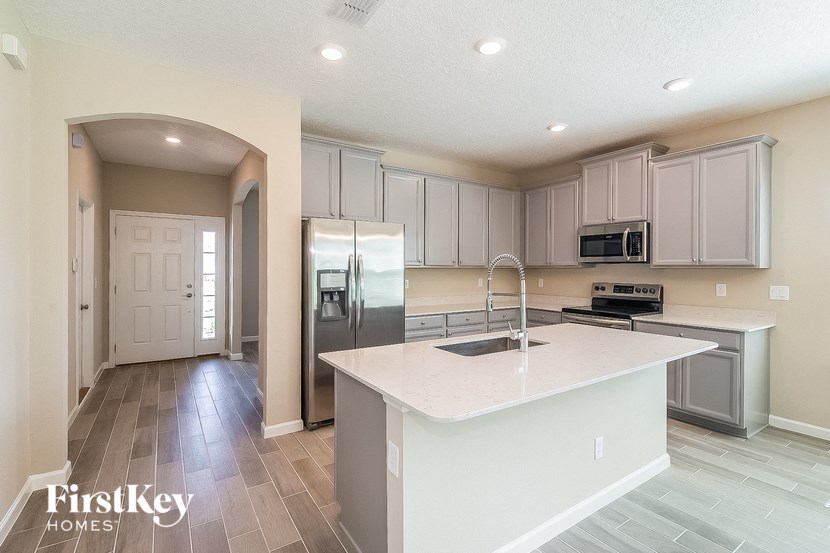 a kitchen with stainless steel appliances and a white counter top