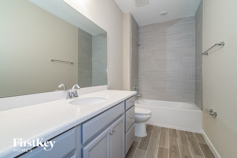 a bathroom with a sink and a toilet and a shower
