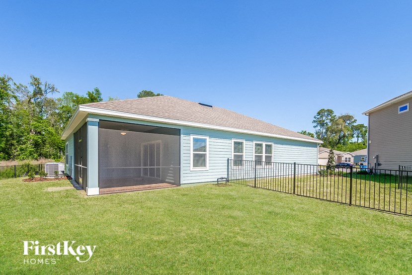 a blue house with a yard and a fence