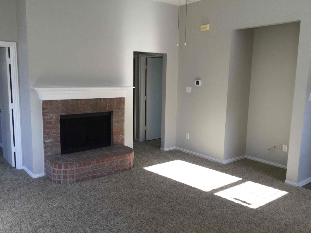 a living room with a fireplace and a door
