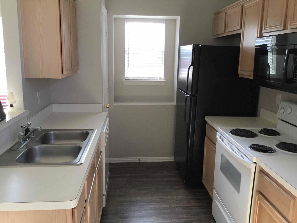 a kitchen with a sink and a refrigerator