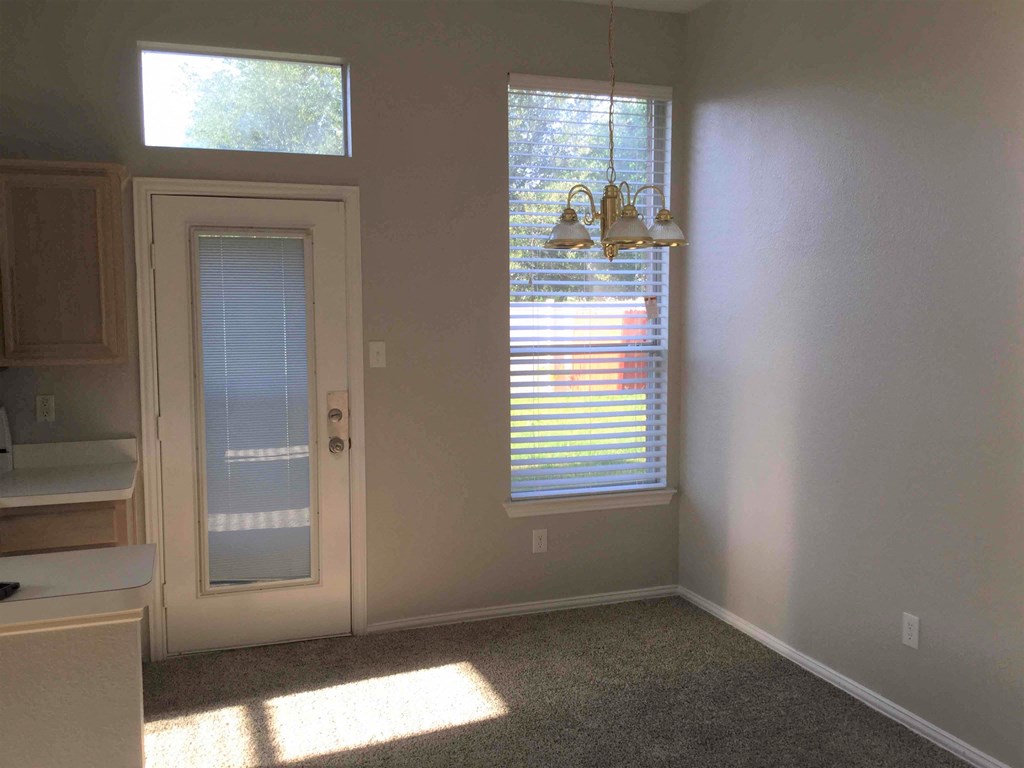 a dining room with a white door and window