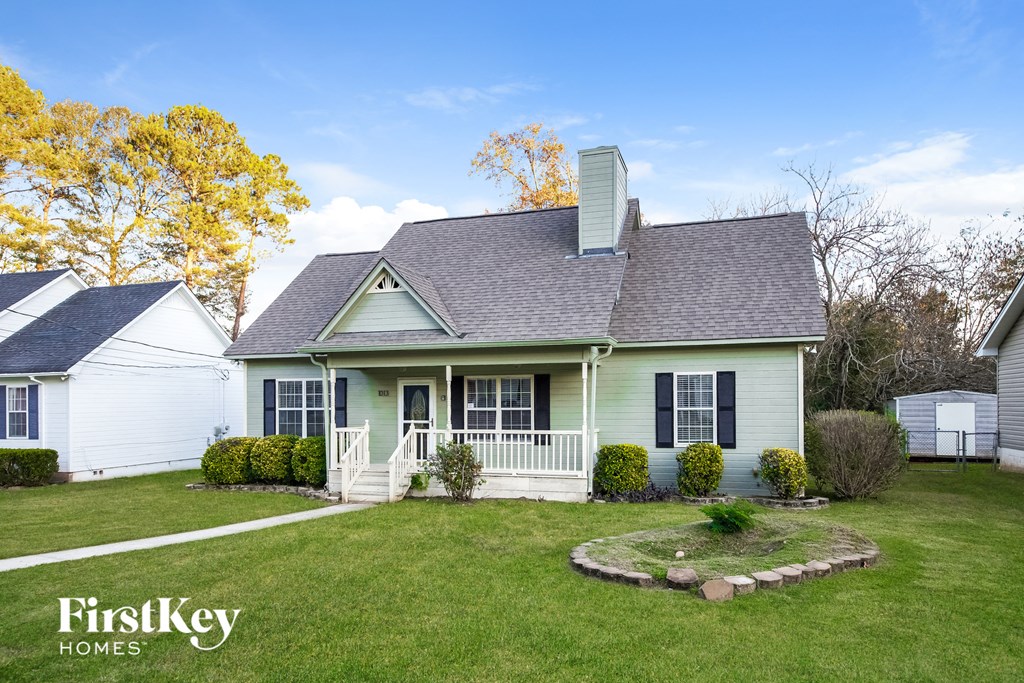 A house with a green front and a white garage door.
