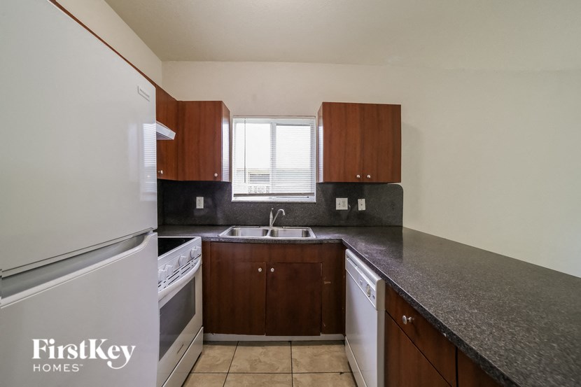 a kitchen with a counter top and a refrigerator