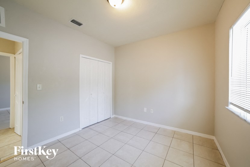 a empty living room with a door to a closet