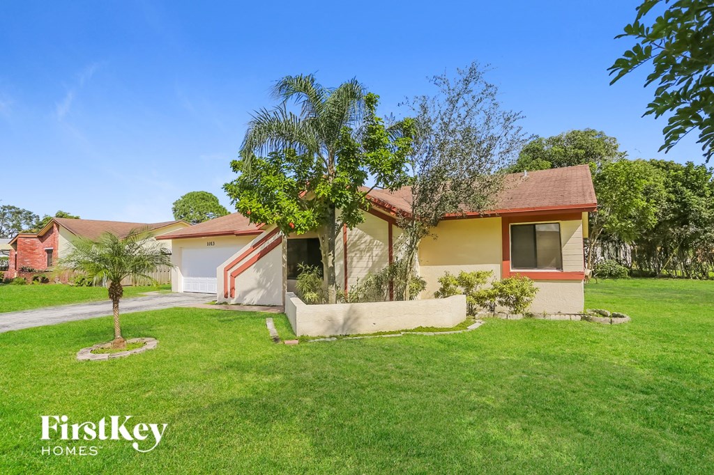 A house with a red roof and a yellow house with a white roof.