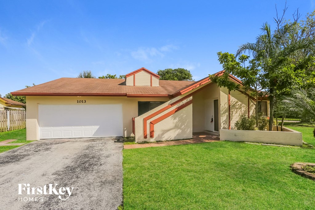 A house with a brown roof and a garage door numbered 1013.