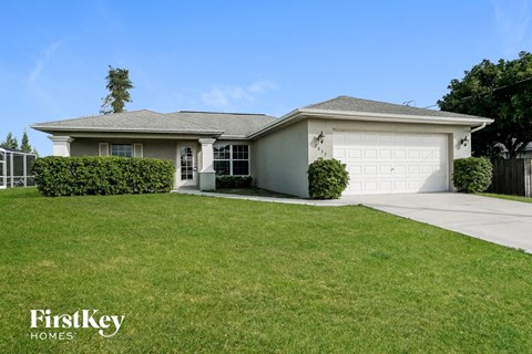 a home with a lawn and a white garage door