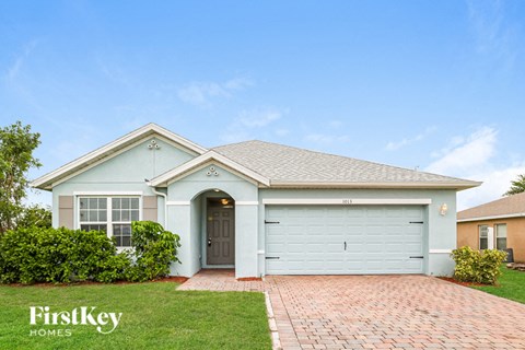 A house with a garage door numbered 101 is for sale.