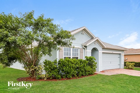 A house with a tree in front of it.