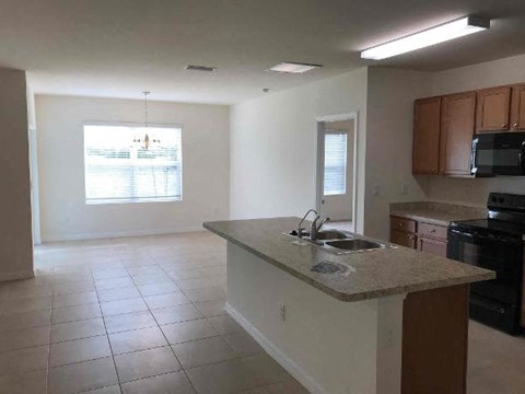 A kitchen with a sink and a window.