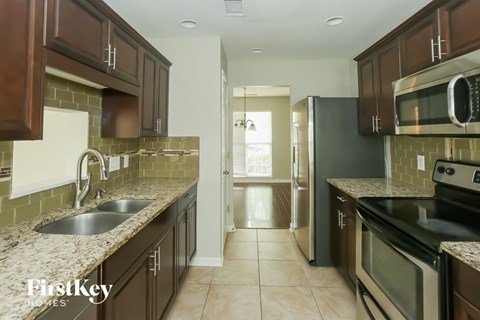 a kitchen with stainless steel appliances and granite counter tops