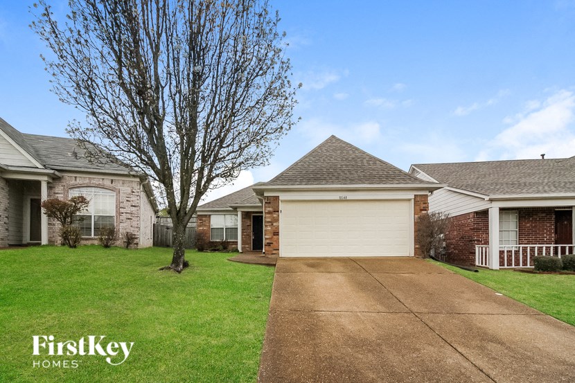 a house with a white garage door and a driveway