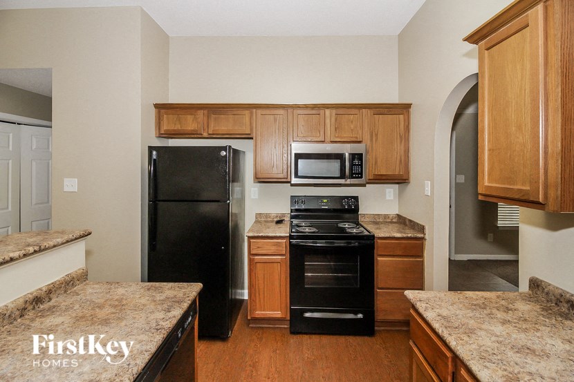 a kitchen with black appliances and granite counter tops