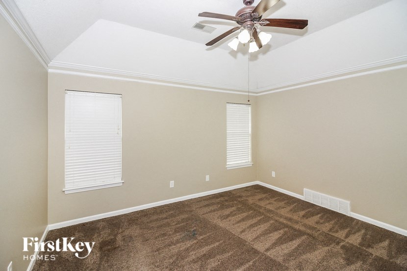 the living room of a home with a ceiling fan