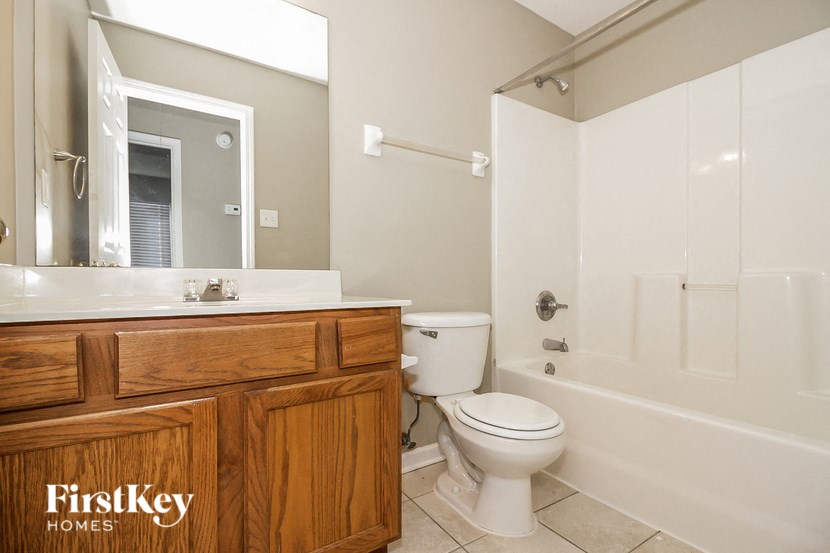 a bathroom with a toilet and a sink and a shower