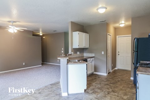 a kitchen with white cabinets and a counter top